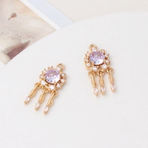 Detailed close-up of dreamcatcher charms with purple zircons and feather tassels