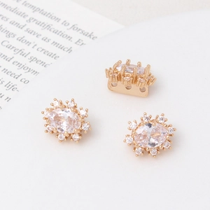 Macro shot of gold-plated windmill flower spacers with zircon for DIY pearl jewelry