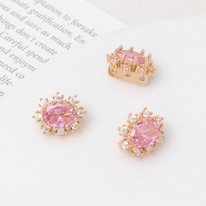 Detail of gold-plated oval pink zircon charm with small white stones for DIY jewelry