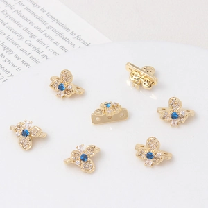 Macro detail of gold plated flower spacer beads with inlaid zircons for DIY jewelry