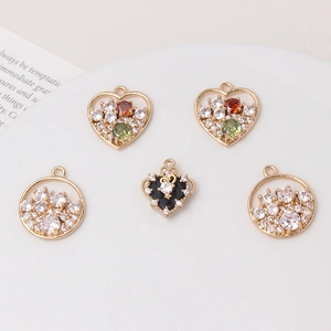 Macro shot of 5 gold DIY jewelry pendants with cubic zirconia for bracelets and necklaces