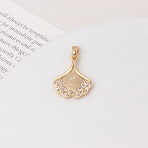 Macro view of gold fan leaf pendant with inlaid zircon and opal stone detail