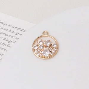 Macro shot of gold circular pendant with pavé zircons on white ceramic plate