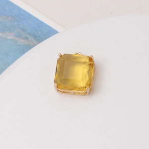 Macro shot of yellow square gemstone pendant with gold-plated four-prong setting