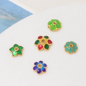 Macro detail of 8mm cloisonné enamel flower bead caps for DIY jewelry crafting