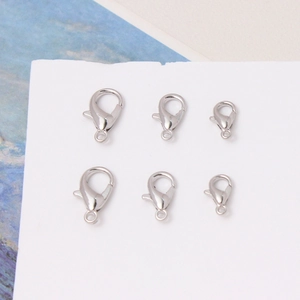 Silver lobster claw clasps for jewelry making in three sizes on a white display card