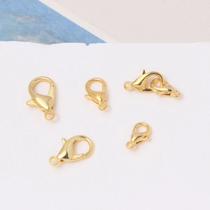 Detailed view of five 18K gold plated lobster clasps in various sizes for DIY jewelry making