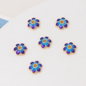 Macro shot of 8mm cloisonne flower beads with blue-purple enamel for DIY jewelry making