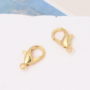 Close-up of 18K gold plated lobster clasps with spring mechanism for DIY jewelry making