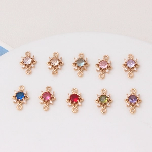 Close-up of ten colorful micro-pave star connectors for DIY jewelry making accessories