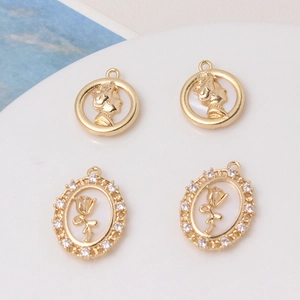 Close-up of gold-plated portrait relief and rose flower oval pendants for DIY jewelry