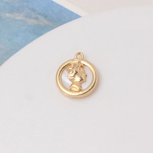 Macro detail of gold-plated oval pendant with white shell carved female portrait