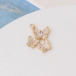 Detail of gold butterfly pendant with white shell wings and shimmering zircon accents