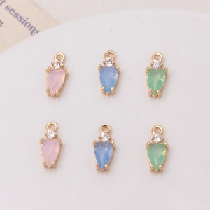 Close-up of heart-shaped zircon pendants in pink, blue, and green for DIY jewelry making