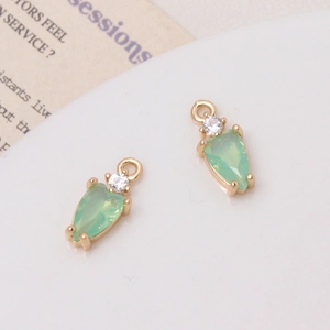 Macro detail of teardrop green crystal charms with cubic zirconia for DIY jewelry