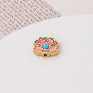 Macro detail of retro gold lotus charm with pink enamel glitter for DIY jewelry making