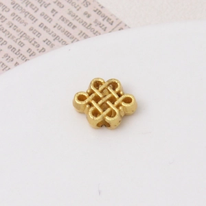 Macro shot of an antique gold alloy Chinese knot charm for DIY jewelry necklace making