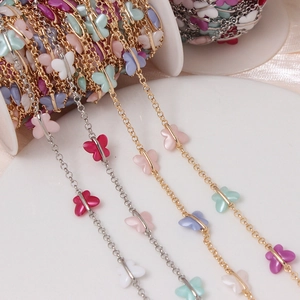 DIY gold and silver chains featuring colorful acrylic butterfly charms on a white spool