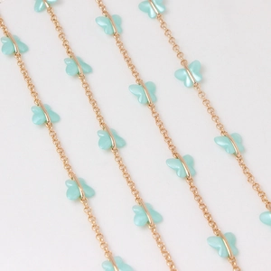 Detail of gold-plated O-chain featuring mint blue acrylic butterfly charms for DIY jewelry