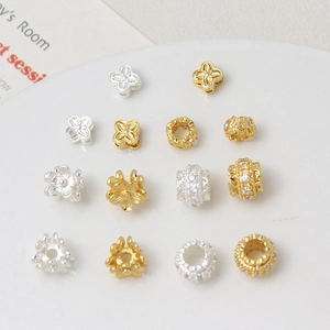 Detailed macro shot of gold and silver plated DIY flower charms and cubic zirconia spacers