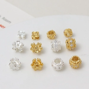 Detailed view of gold and silver plated flower beads with micro-set zircon for DIY jewelry