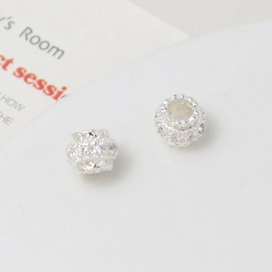 Macro shot of silver plated spacer beads with white cubic zirconia for DIY jewelry