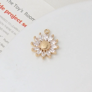 Macro view of gold daisy pendant with marquise-cut zircon petals for DIY jewelry
