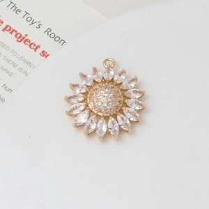 Macro view of sunflower pendant with marquise-cut zircons and gold-plated copper finish