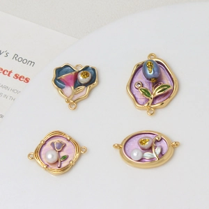 Macro detail of floral enamel pendants with pearls and dual rings for DIY jewelry