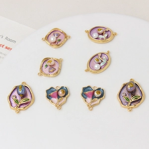 Detail view of handmade enamel flower charms with freshwater pearls for jewelry DIY making