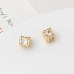 Macro detail of 18k gold plated cube spacers with cubic zirconia for jewelry making