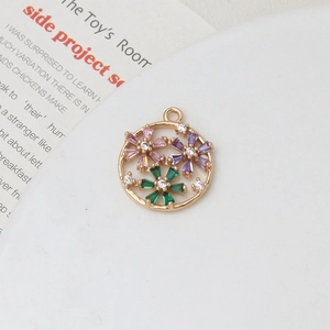 Macro shot of gold daisy pendant with pink and purple zircon petals for DIY jewelry