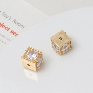 Detailed macro view of 18k gold plated hollow cube beads with micro-pave cubic zirconia