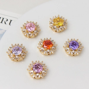 Macro view of sunflower-shaped gold pendants with colorful rose-cut gemstones and diamonds