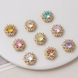 Detailed view of nine colorful rose-cut zircon snowflake charm beads for DIY jewelry