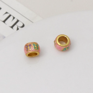 Detail of pink enamel butterfly beads with gold edges for DIY bracelet jewelry making