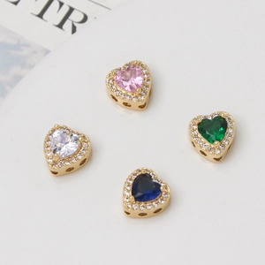 Detailed view of colorful heart-shaped gold plated charms with micro zircon inlay