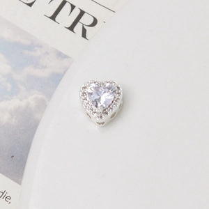 Macro shot of silver heart charm bead with zircon inlay for DIY bracelet and necklace