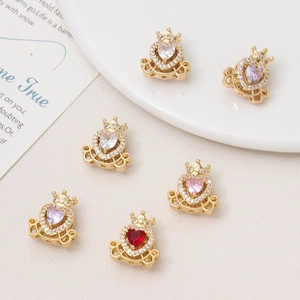 Detailed macro of openwork crown carriage charms with heart-shaped zircon stones