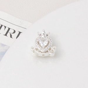 Macro shot of silver plated heart crown carriage charm with zircon stones for DIY jewelry