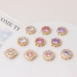 Macro detail of geometric zircon connector charms in pink, purple and white for DIY jewelry