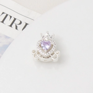 Macro shot of silver crown carriage pendant featuring a purple heart zircon stone