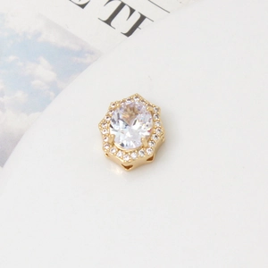 Macro detail of geometric gold bead with oval zircon for multi-row pearl jewelry making