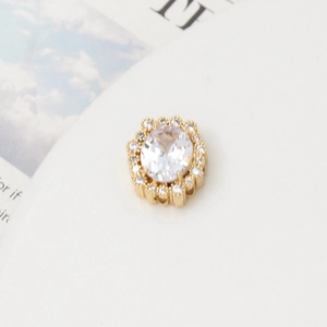 Macro detail of gold flower cluster jewelry bead with oval zircon and small diamonds