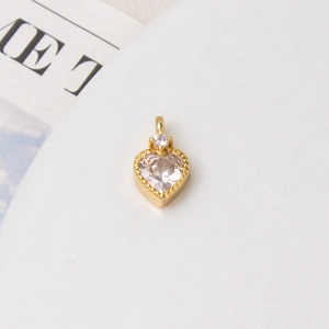 Macro shot of heart-shaped zircon pendant with gold-plated setting for jewelry making