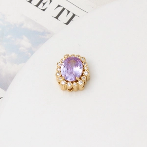 Macro detail of lavender oval zircon pendant with white halo crystals on gold base