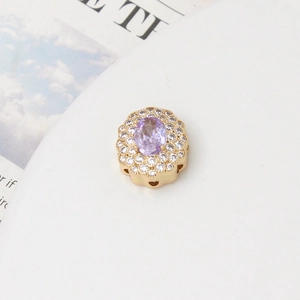 Detailed side view of gold floral pendant with purple stone and heart cut-outs