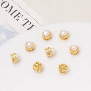 Set of eight 18K gold plated freshwater pearl beads with hollow clover patterns