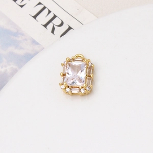 Detailed macro view of a gold-plated rectangular pendant with micro-pave zircon crystals