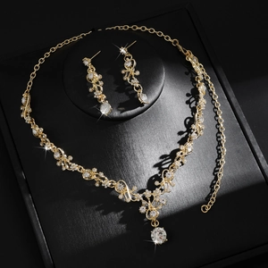Elegant gold-tone bridal jewelry set with floral rhinestone necklace and drop earrings